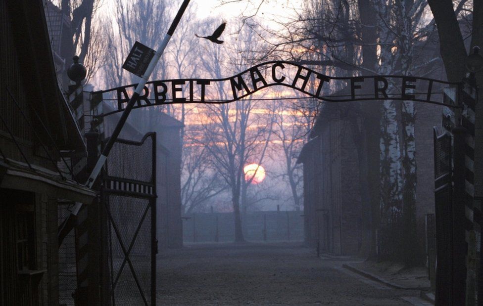 The main gates at the entrance to the Auschwitz I Nazi concentration camp in Oswiecim, Poland, pictured as the sun sets