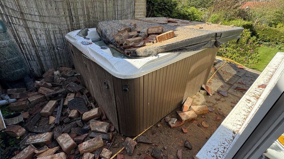 A hot tub with debris on top of it