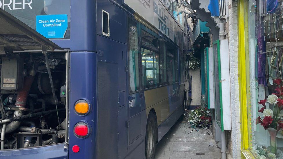 Somerset bus crashes into shop front in Glastonbury