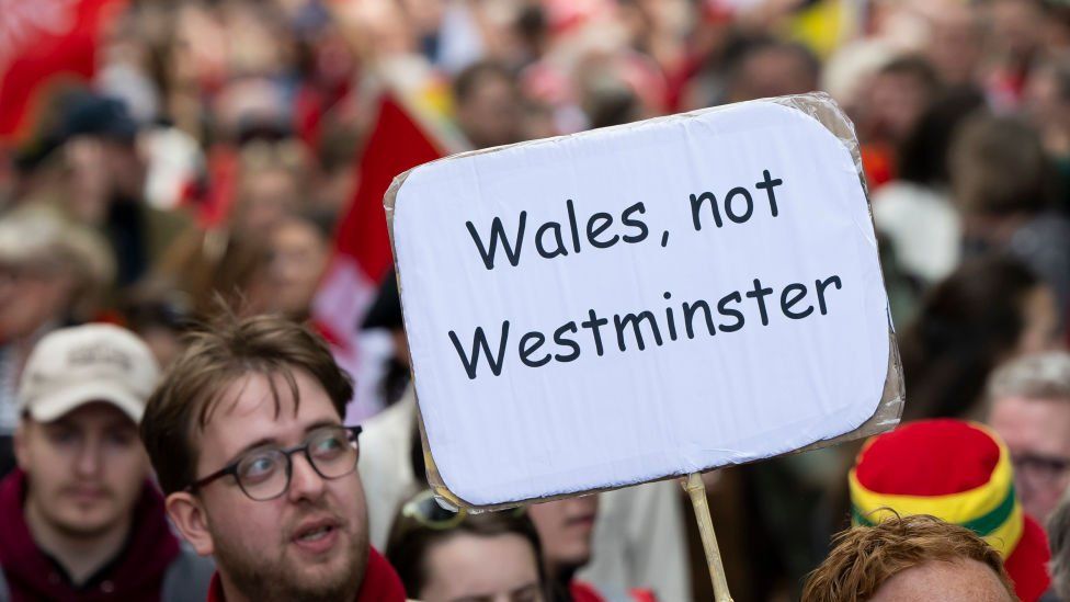 man holding sign at march