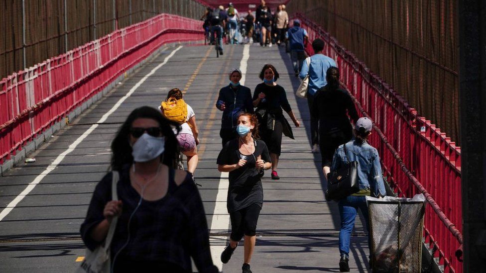 People crossing the Williamsburg bridge in New York wearing face masks