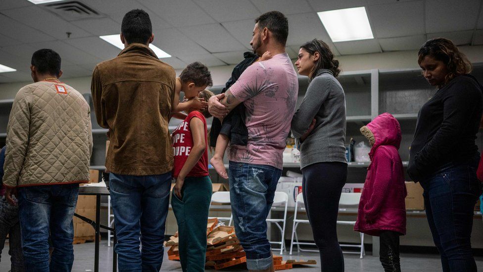 Migrants wait to receive food at the Casa del Refugiado, or The House of Refugee, a new centre opened by the Annunciation House to help the large flow of migrants being released by the United States Border Patrol and Immigration and Customs Enforcement in El Paso, Texas