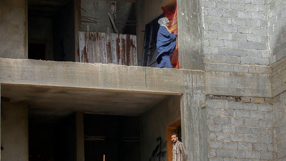 Displaced Libyans are pictured in an unfinished building in the Libyan capital Tripoli on December 18, 2019.