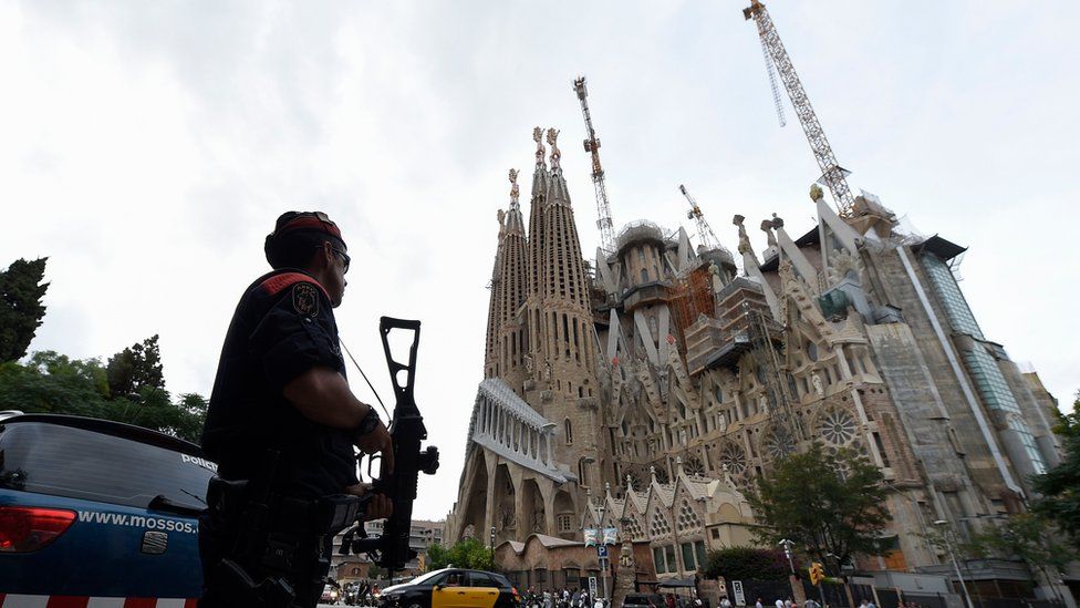 Police officers stand guard in front of the "Sagrada Familia" (Holy Family) basilica in Barcelona on August 19, 2017