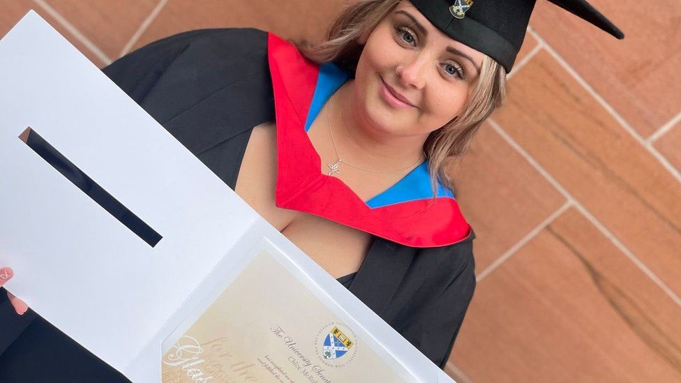 Chloe McRoberts holding her degree