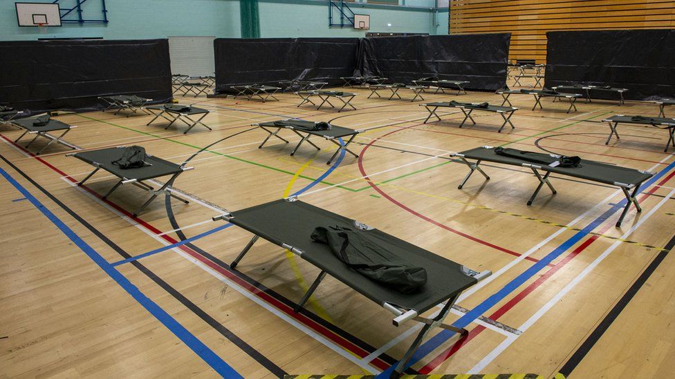 Wide shot of beds in gym