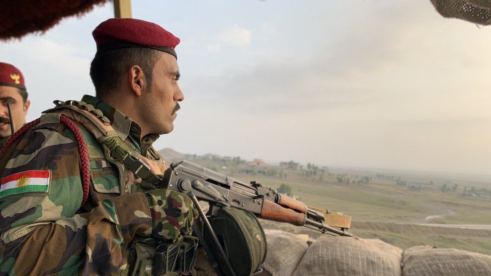 Peshmerga fighter looks out across no man's land