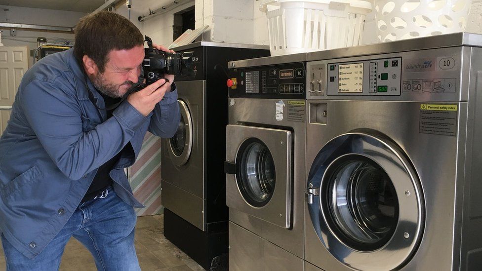 Joe Gudgeon taking photo of washing machine