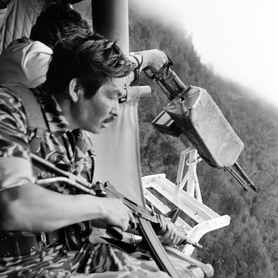 Guatemalan soldiers prepare to fire on Mayan Indians from a US-made Bell helicopter near Santa Cruz del Quiché (1982)