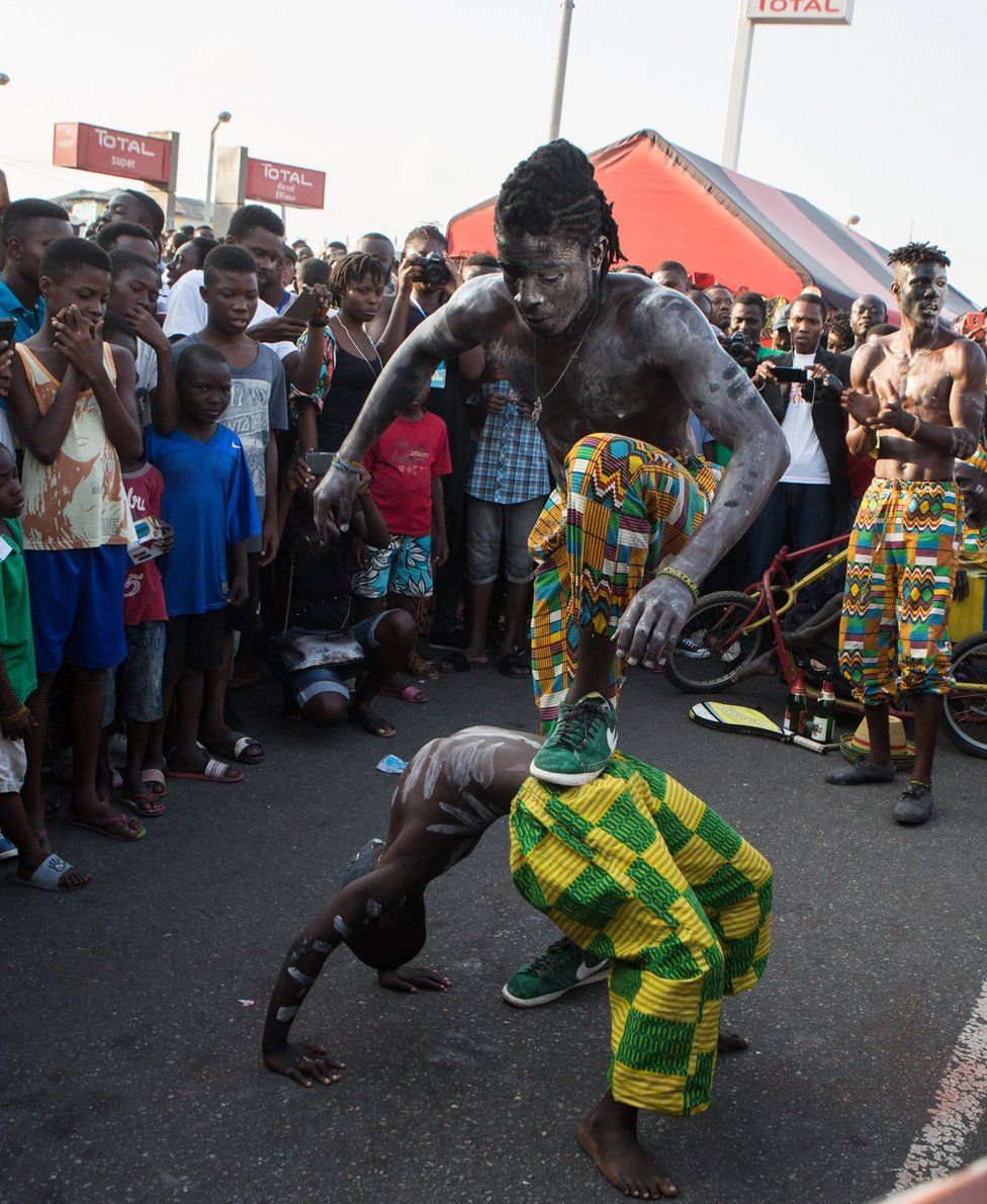 picture taken on August 19, 2017 shows acrobats performing during the annual Chale Wote Street Art Festival at James town in Accra.