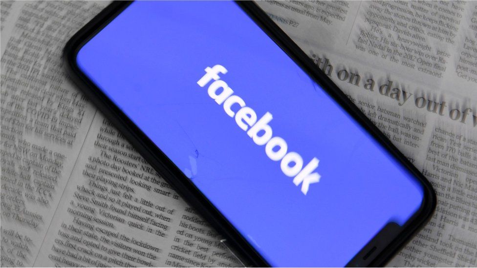 An illustration image shows a phone screen with the Facebook logo and Australian Newspapers at Parliament House in Canberra, Australia, 18 February 2021.