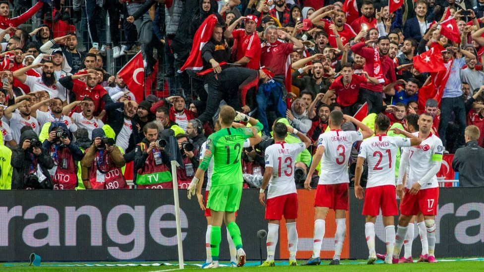 The Turkish players' military salute was greeted by fans copying their actions at the Stade de France on Monday night