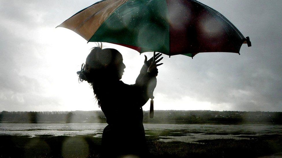 Woman struggling with umbrella