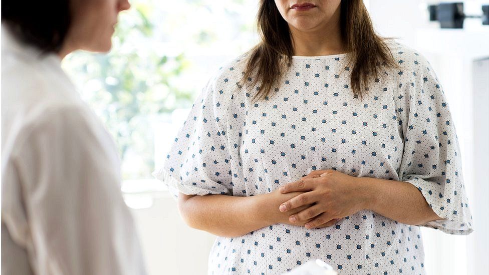 Woman in a hospital gown