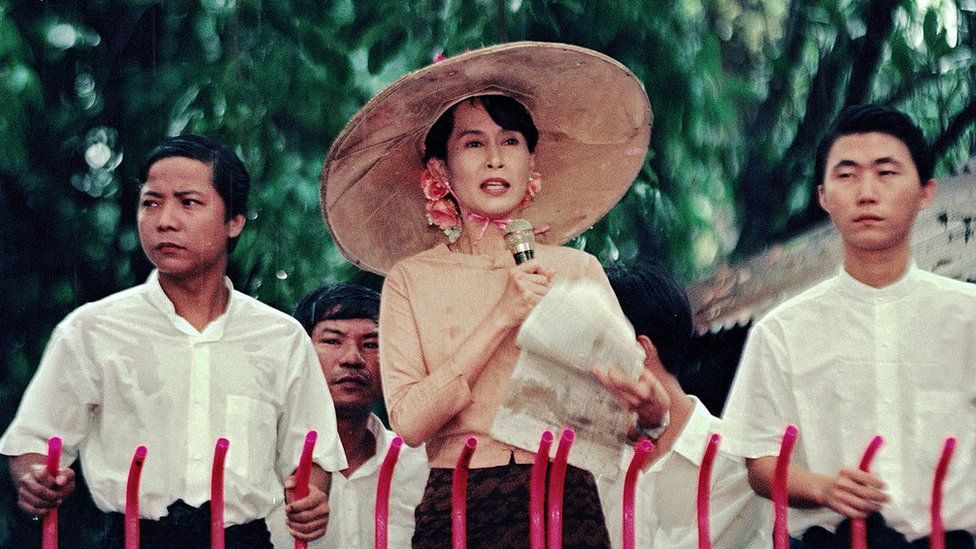 Aung San Suu Kyi addresses supporters gathered outside her home in Myanmar in this file photo from 1996