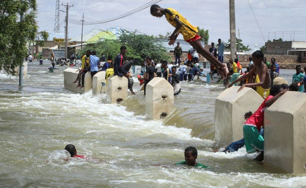 A boy dives into floodwater in Beledweyne, central Somalia, on May 14, 2023.