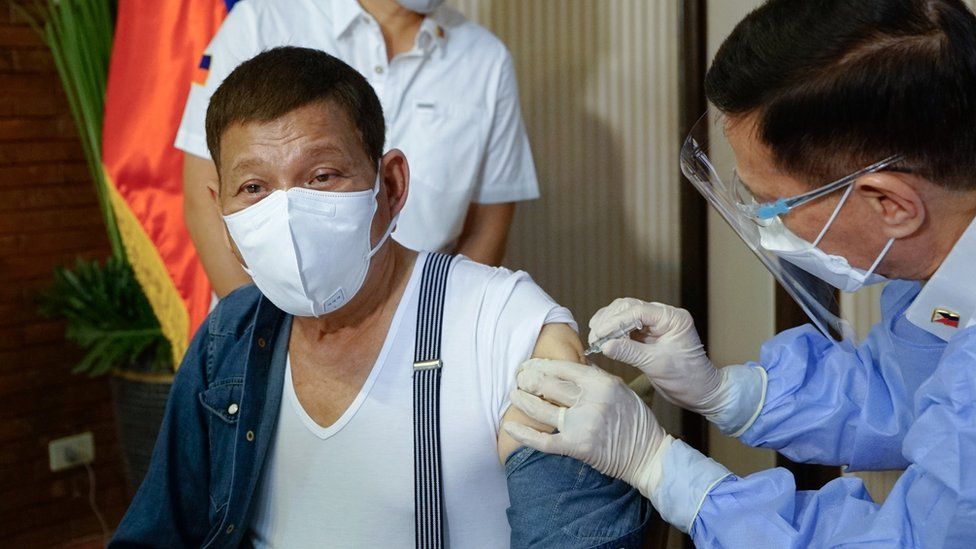 Rodrigo Duterte getting a vaccine shot