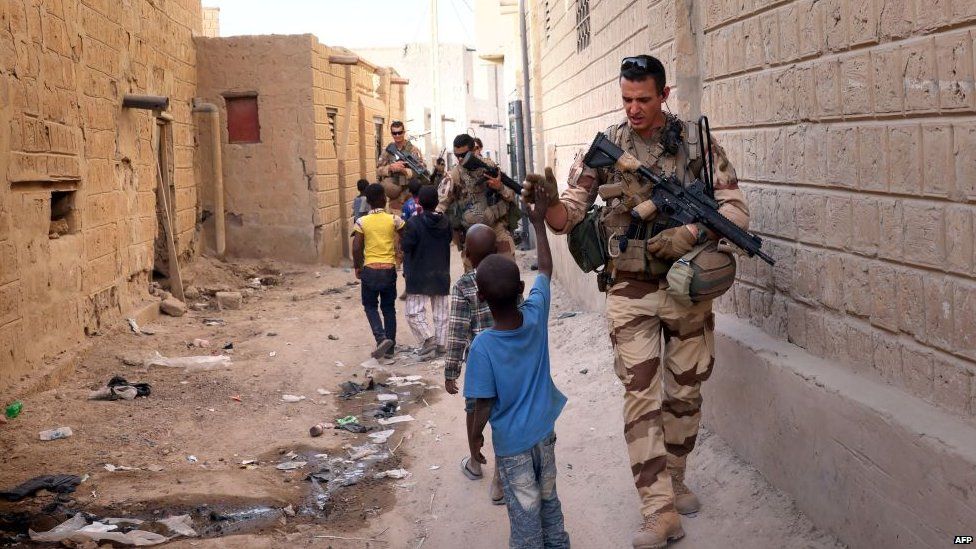 French soldiers of the Barkhane force patrol the streets of Timbuktu, northern Mali, on 5 December 2021.