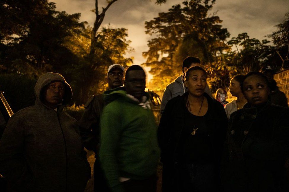 People wait for family members to be evacuated from the DusitD2 compound in Nairobi after a blast followed by a gun battle rocked the upmarket hotel complex on January 15, 2019.