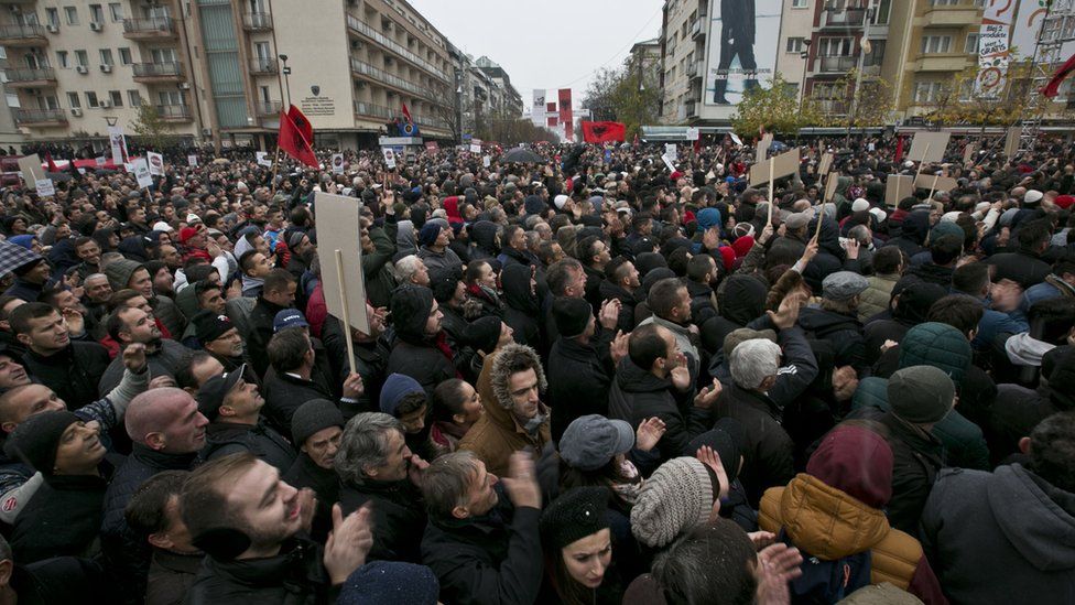 Kosovo policemen detain a man at the Vetevendosje headquarters after several thousand of supporters of opposition party gathered in downtown Pristina