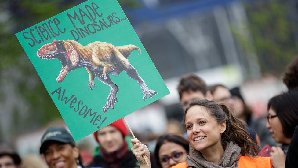 A woman holds a sign as she participates in the March for Science in Vienna, Austria, 22 April 2017