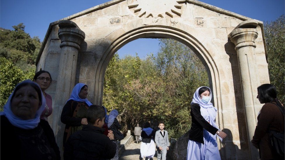 People walk through an arch in Lalish, the Yazidis' holiest site