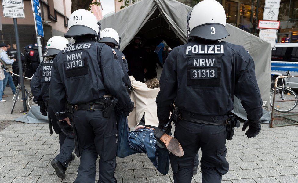 Police break up the demonstration from the PRO NRW and carry away a protestor at the main station in Cologne, Germany, 31 July 2016