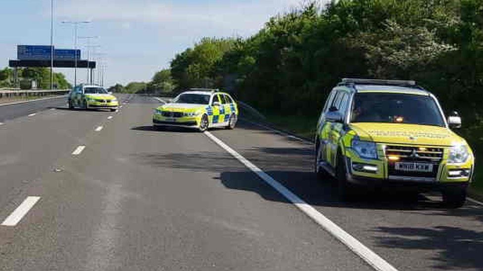 Three police cars on the M11, Essex