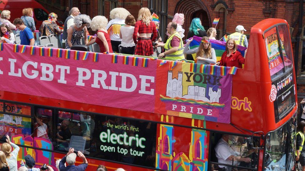 York Pride revellers on an open-top bus in York