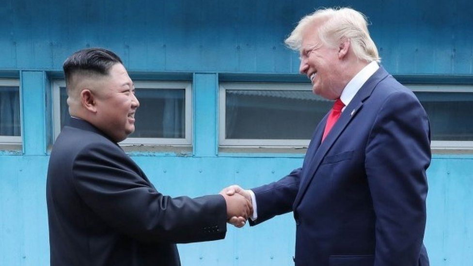 Kim Jong-un and Donald Trump shake hands at the DMZ (30 June 2019)