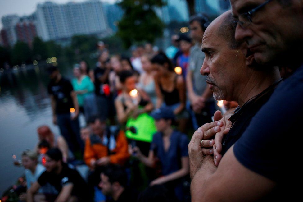 Wilfredo Perez (L), a local bartender at a gay bar, is embraced by his partner Jackson Hollman during a vigil to commemorate victims of a mass shooting at the Pulse gay night club in Orlando, Florida, 12 June 2016