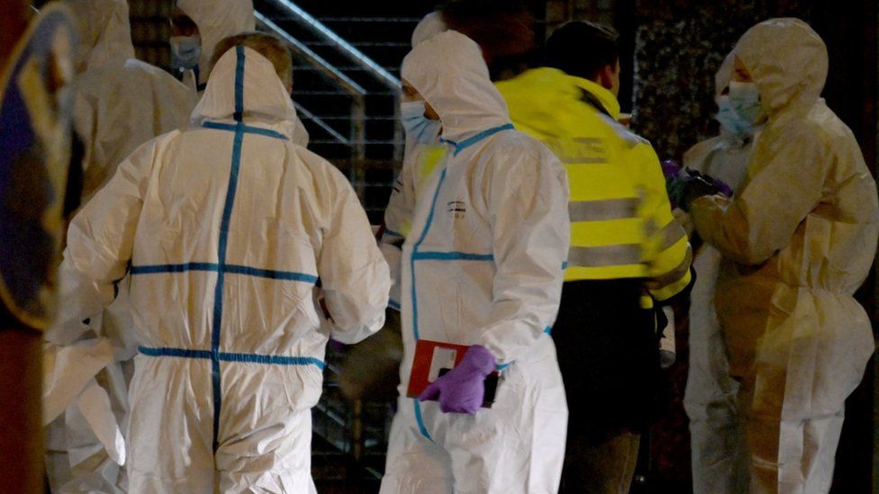 Forensic experts work at the scene of the shooting in Hamburg, Germany