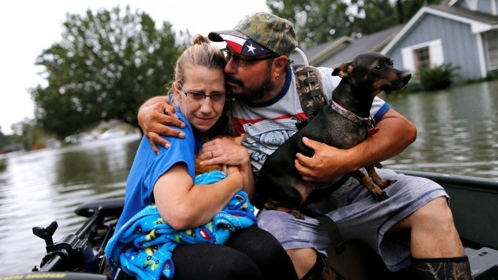 David Gonzalez comforts his wife Kathy after being rescued from their home flooded by Tropical Storm Harvey in Orange, Texas, 30 August 2017
