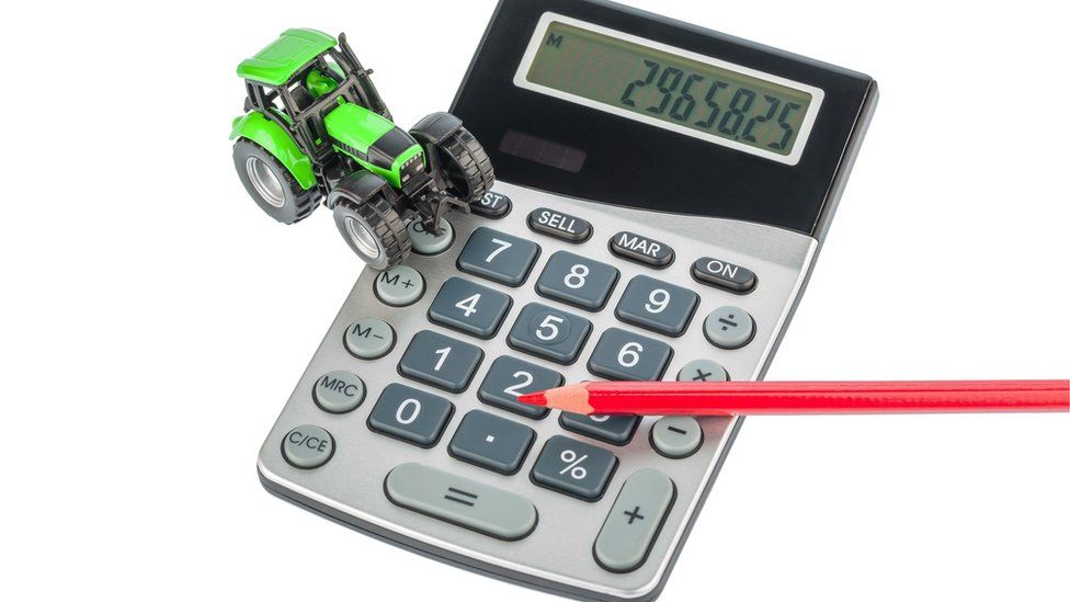 Calculator, pencil and toy tractor