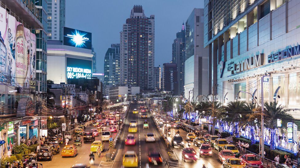 Bangkok, busy road at night, with taxis waiting outside busy shopping complex