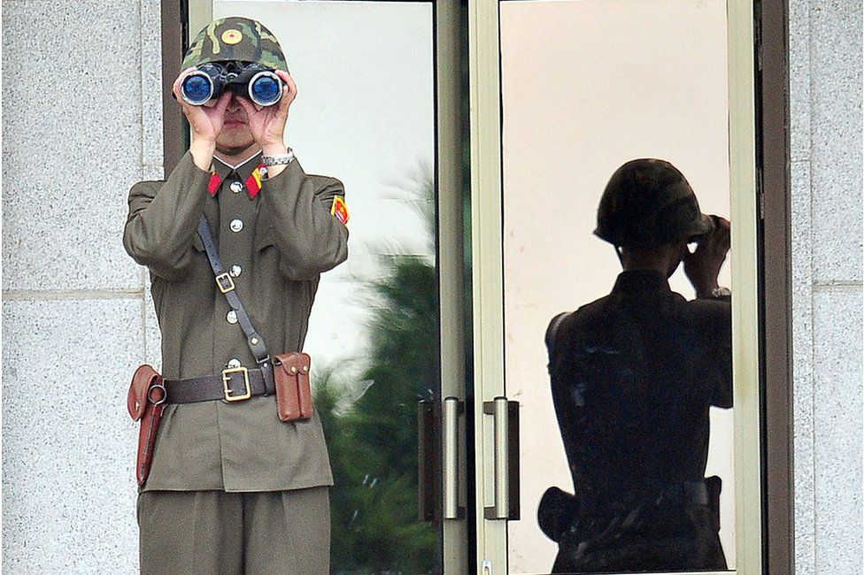 A North Korean soldier looks at the South side as government delegations from the UN allied nations visit the truce village of Panmunjom in the Demilitarized zone (DMZ) dividing the two Koreas on 27 July 2013 to mark the 60th anniversary of ceasefire agreement and UN forces' participation in the Korean War.