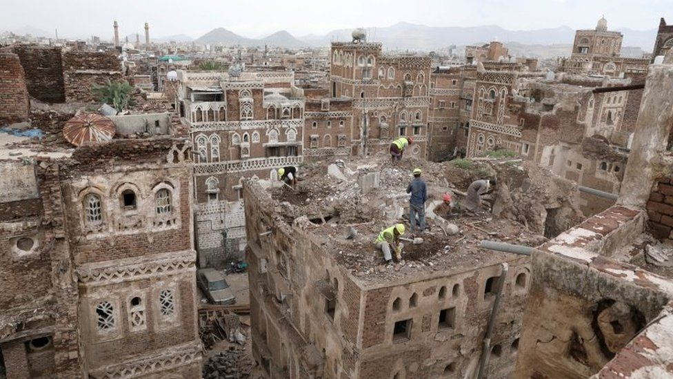 Workers demolish a rain-damaged building in the Old City of Sanaa, Yemen (9 August 2020)