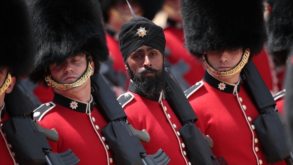 Coldstream Guards soldier Charanpreet Singh Lall marches during Trooping The Colour parade on 9 June