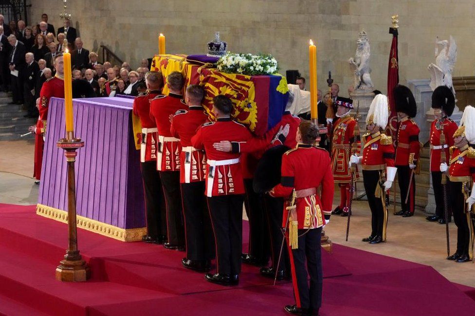 The Queen's coffin being carried into place in Westminster Hall