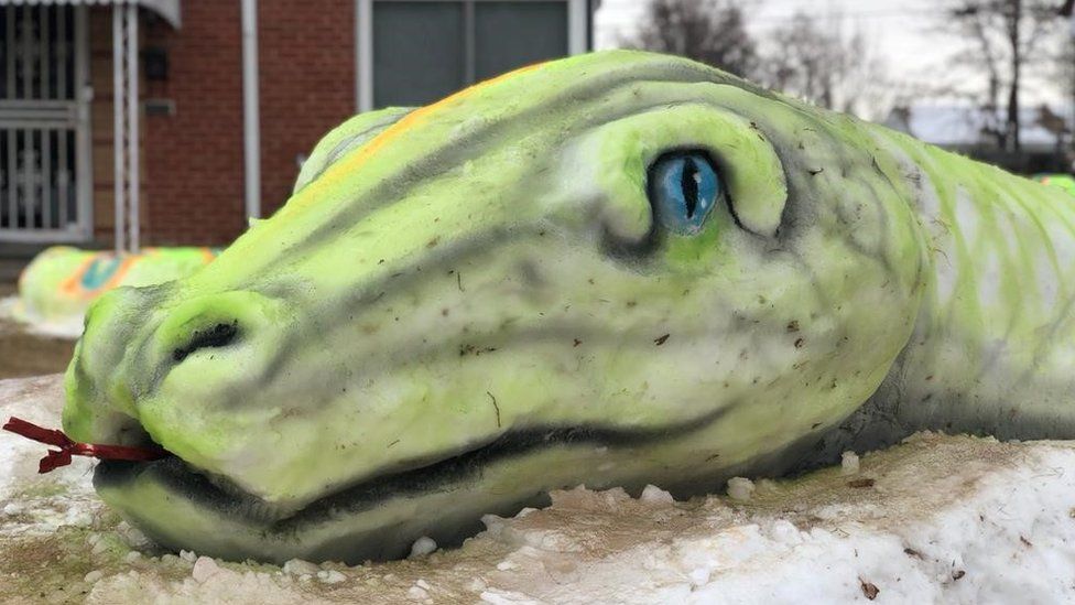 A snow sculpture of a snake