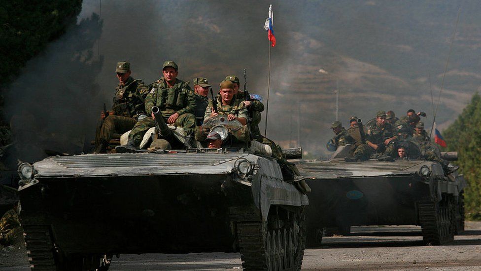 Russian soldiers ride armoured personnel carriers on August 16, 2008 near Gori, Georgia.