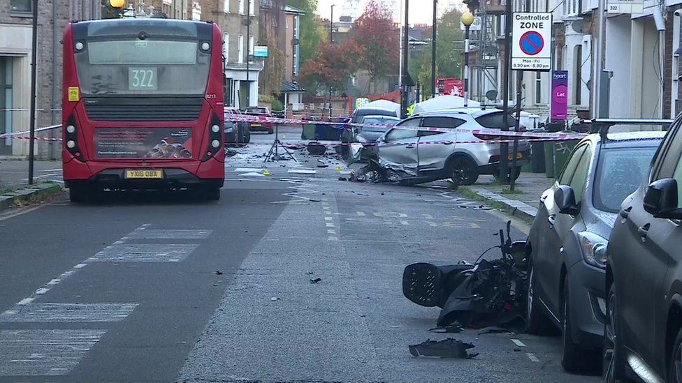 Scene of the incident showing destroyed car and motorbike