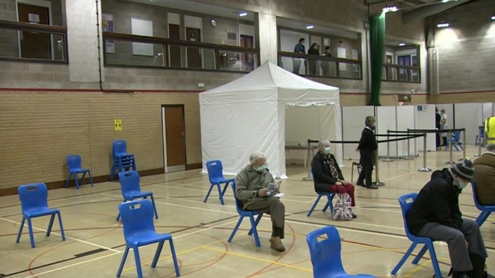 People waiting for vaccinations at Gainsborough Sports Centre in Ipswich