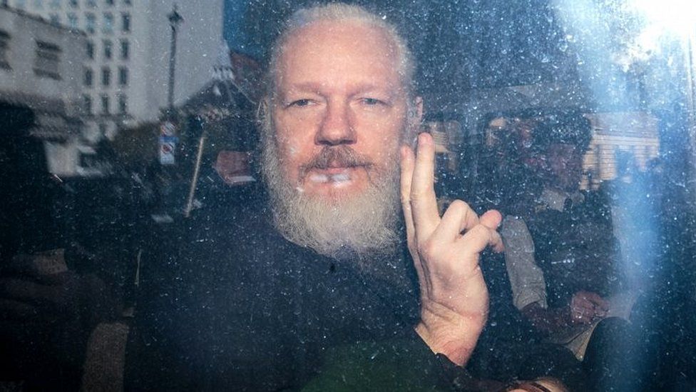Julian Assange pictured in a police van