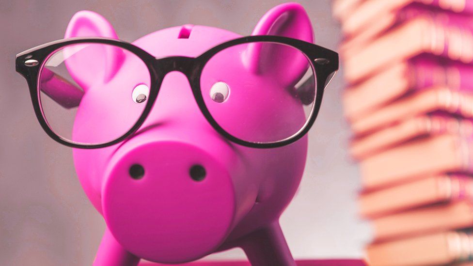 A piggy bank with glasses on