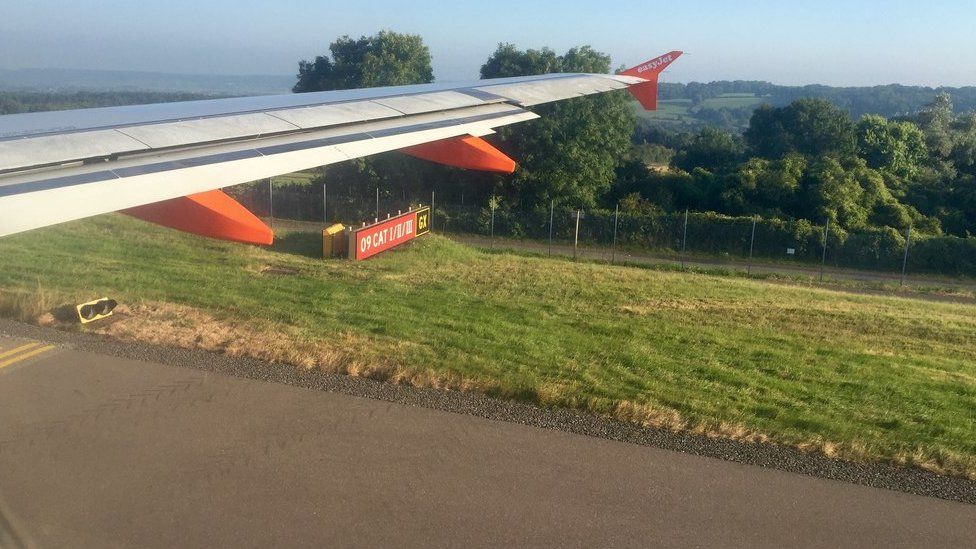 Plane wing with countryside in background