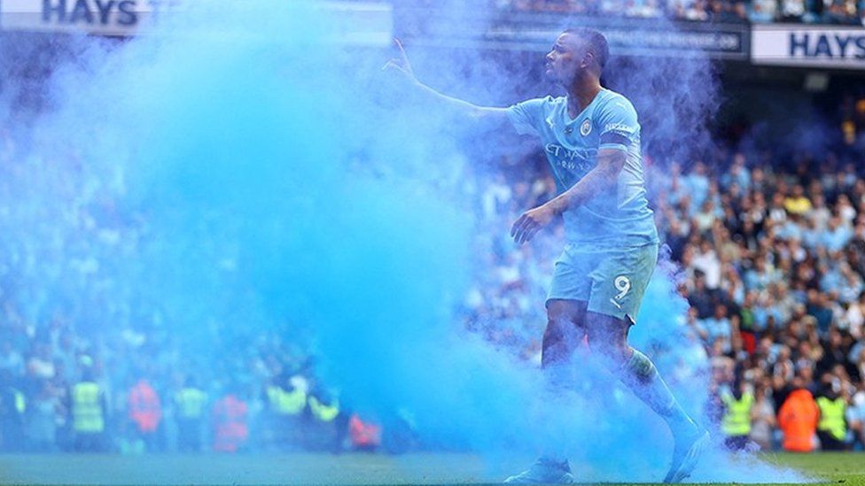 Manchester City's Gabriel Jesus reacts after a flare is thrown onto the pitch