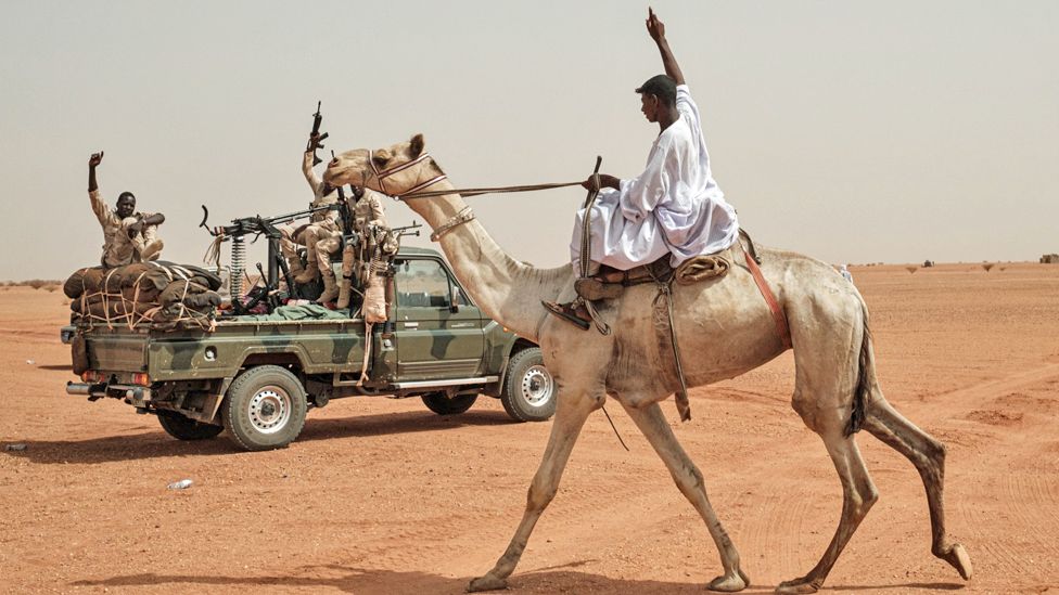 A man riding on a camel greets members of the Rapid Support Forces (RSF) paramilitaries before a rally in Abraq, in 2, 2019. (P