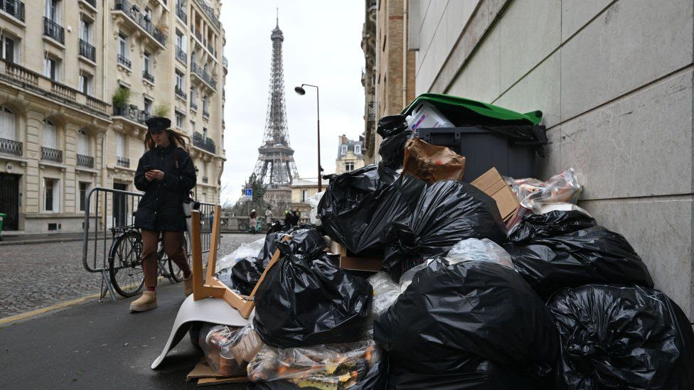 Garbage cans overflowing with trash on the streets as collectors go on strike in Paris, France on March 13, 2023. Garbage collectors have joined the massive strikes throughout France against pension reform plans.