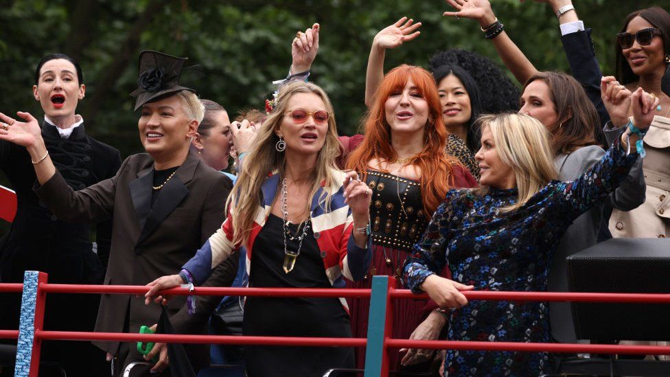 Erin O'Connor, Kate Moss, Charlotte Tilbury and Naomi Campbell ride a bus along the mall during the Platinum Pageant